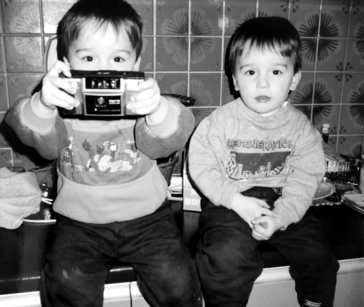 Marcel and Dennis Hanke as kids, one holding a camera